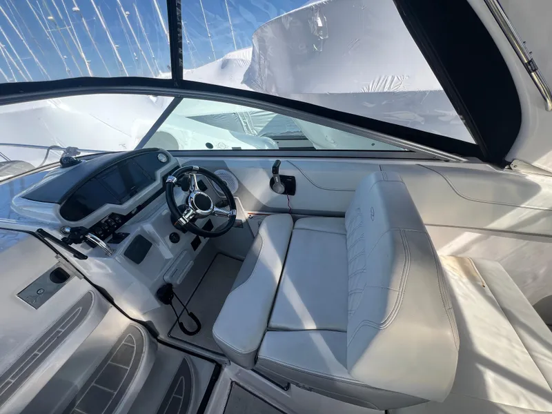 Slide: The Image of 2020 Regal 26 XO boat interior with sleek white seating and modern dashboard. - 19