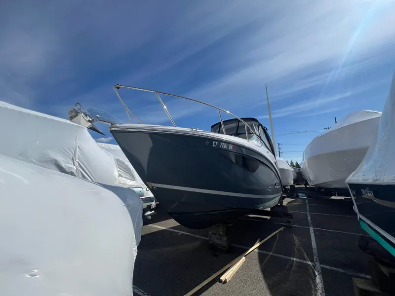 Slide: The Image of 2020 Regal 26 XO boat in storage, surrounded by other covered vessels. - 2