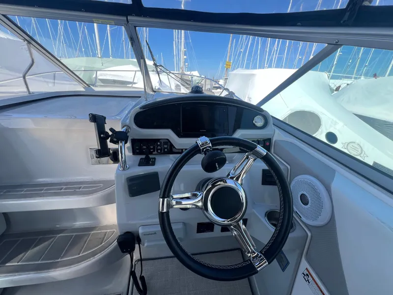 Slide: The Image of 2020 Regal 26 XO boat helm with steering wheel and control panel. - 20