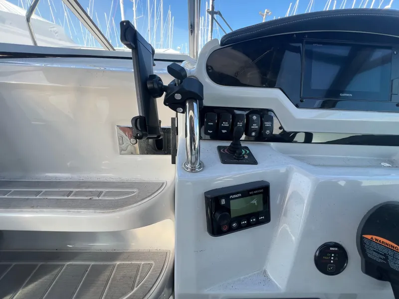 Slide: The Image of 2020 Regal 26 XO boat dashboard with controls and navigation display. - 22