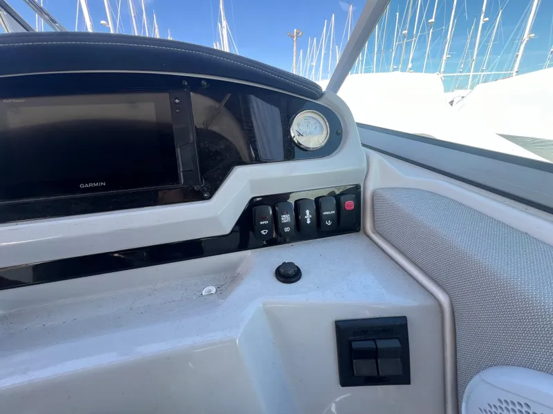 Slide: The Image of Control panel of 2020 Regal 26 XO boat with navigation system and switches. - 23