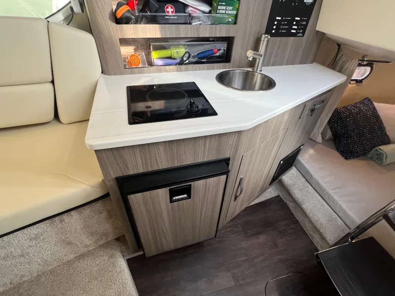 Slide: The Image of Compact kitchen area in a 2020 Regal 26 XO boat with sink and stove. - 29