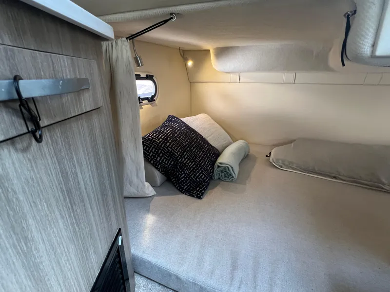 Slide: The Image of Cozy cabin interior of 2020 Regal 26 XO boat with bed and pillows. - 31