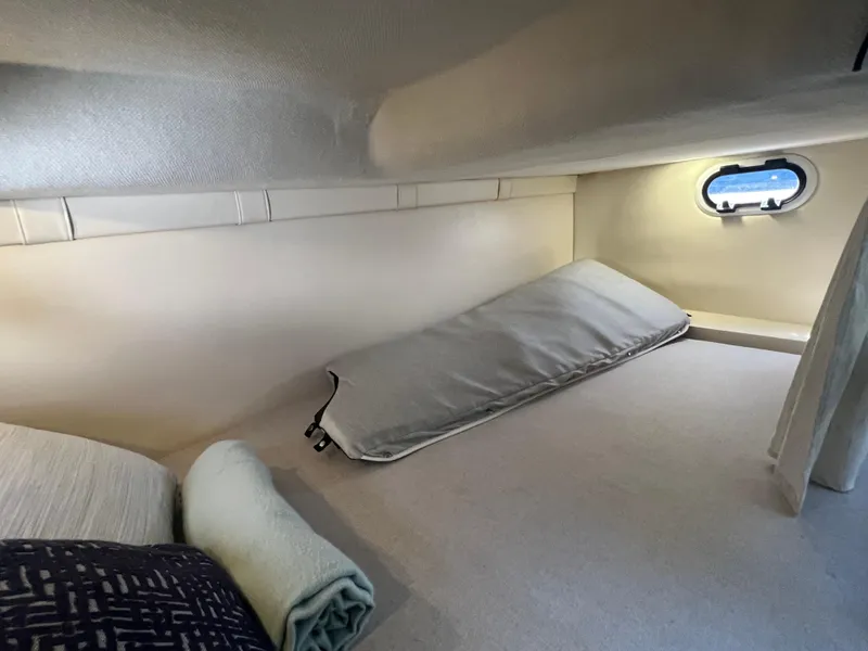 Slide: The Image of 2020 Regal 26 XO cabin interior with bedding and small window. - 33