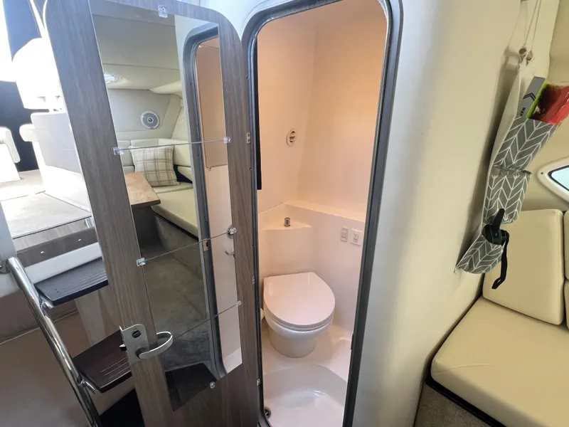 Slide: The Image of 2020 Regal 26 XO boat interior with compact bathroom and seating area. - 38