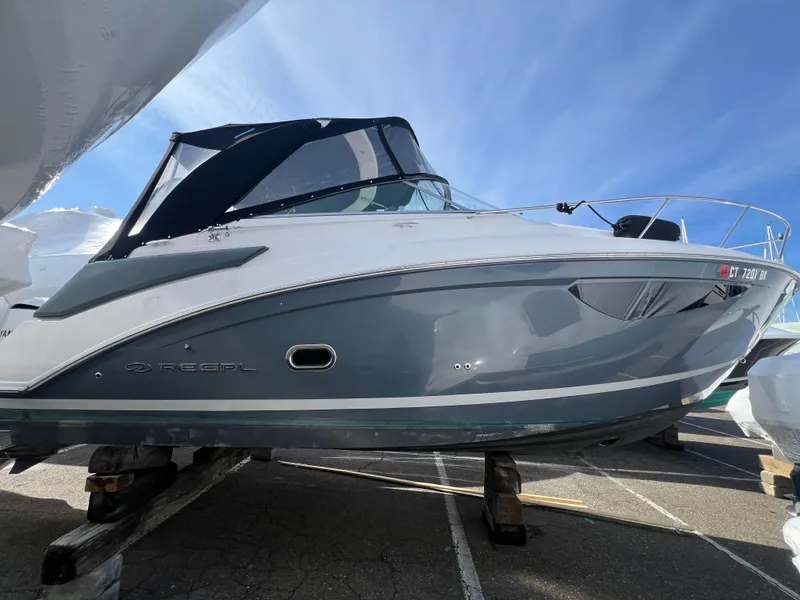Slide: The Image of 2020 Regal 26 XO boat with sleek design, docked under clear blue sky. - 4