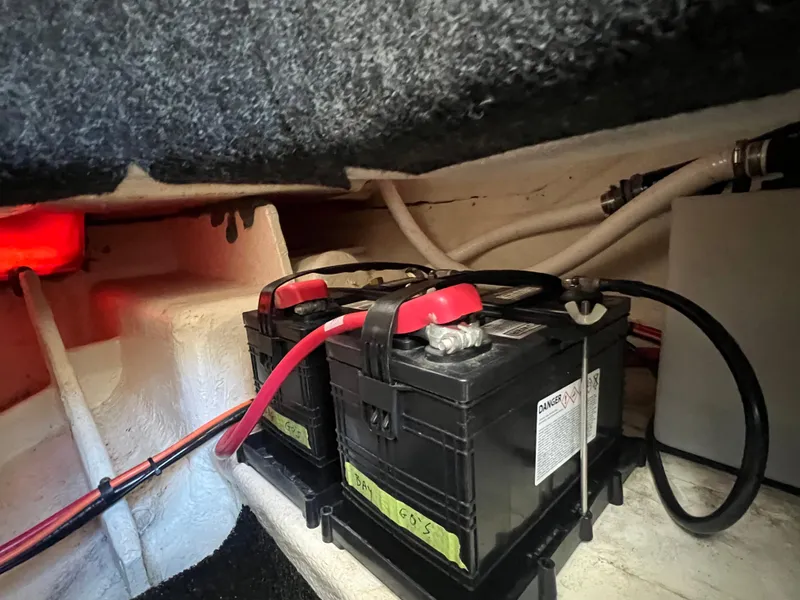 Slide: The Image of Battery compartment of a 2020 Regal 26 XO boat, featuring dual batteries and wiring. - 43