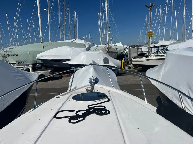 Slide: The Image of 2020 Regal 26 XO boat docked among covered vessels in a marina. - 45