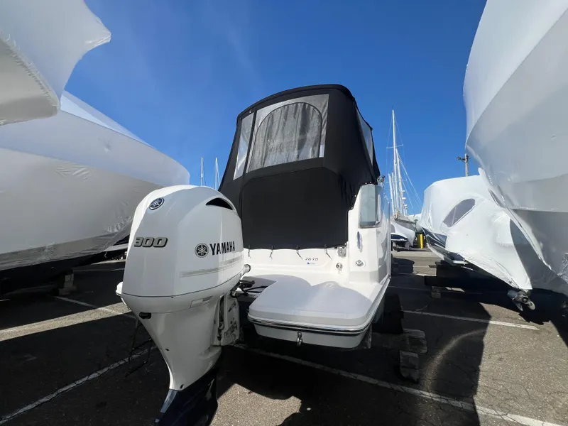 Slide: The Image of 2020 Regal 26 XO boat with Yamaha 300 outboard engine, docked under clear blue sky. - 8