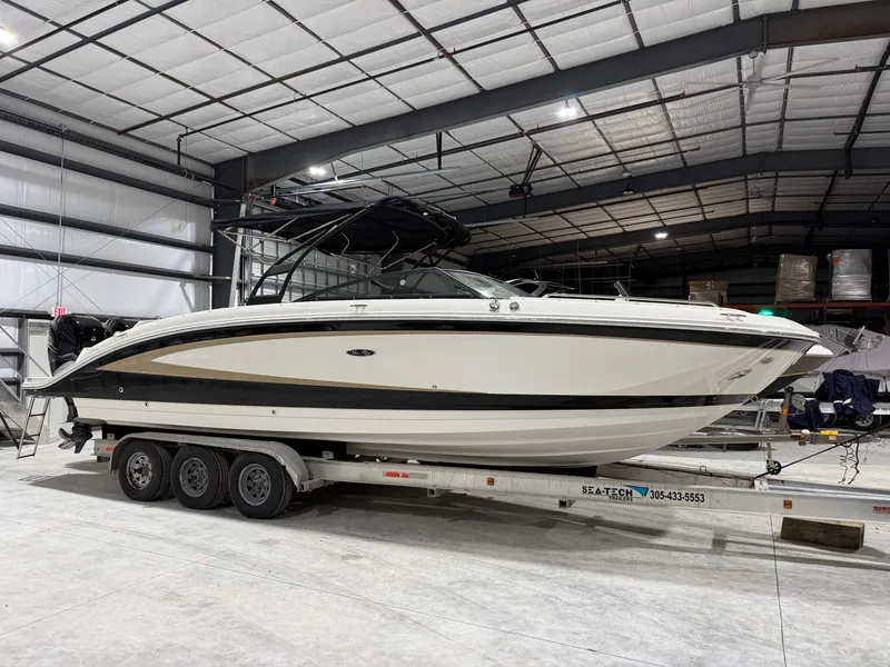 Slide: The Image of 2016 Sea Ray 290 Sundeck Outboard on trailer in indoor storage facility. - 2