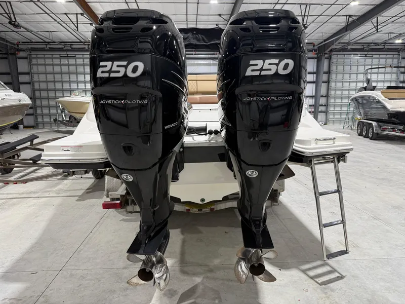 Slide: The Image of Twin 250 horsepower outboard engines on a 2016 Sea Ray 290 Sundeck in a warehouse. - 4