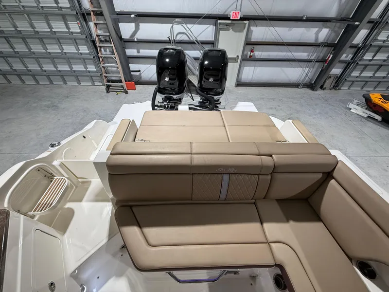 Slide: The Image of 2016 Sea Ray SDX 290 Outboard with dual engines and beige seating in a garage. - 13