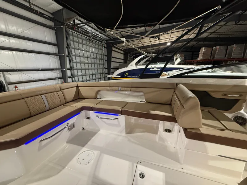 Slide: The Image of 2016 Sea Ray SDX 290 Outboard interior with beige seating in a storage facility. - 14