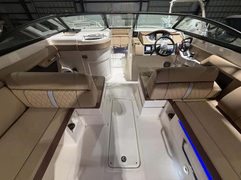 Slide: The Image of 2016 Sea Ray SDX 290 Outboard interior with beige seating and modern dashboard. - 17