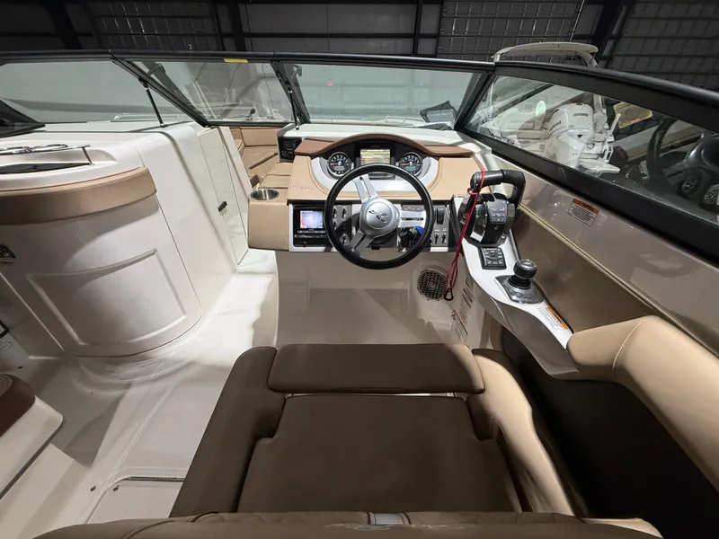 Slide: The Image of 2016 Sea Ray SDX 290 Outboard boat interior with steering wheel and control panel. - 18
