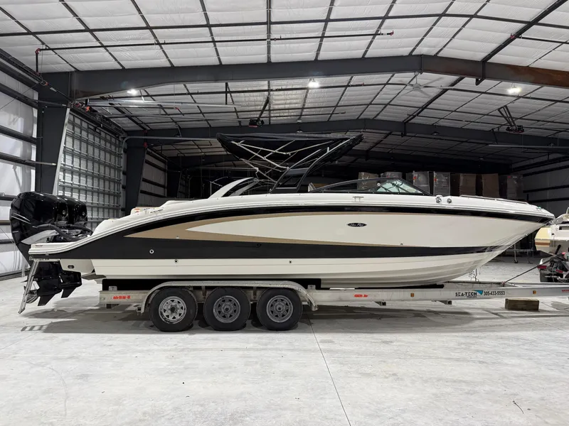 Slide: The Image of 2016 Sea Ray SDX 290 Outboard boat on trailer in indoor storage facility. - 2