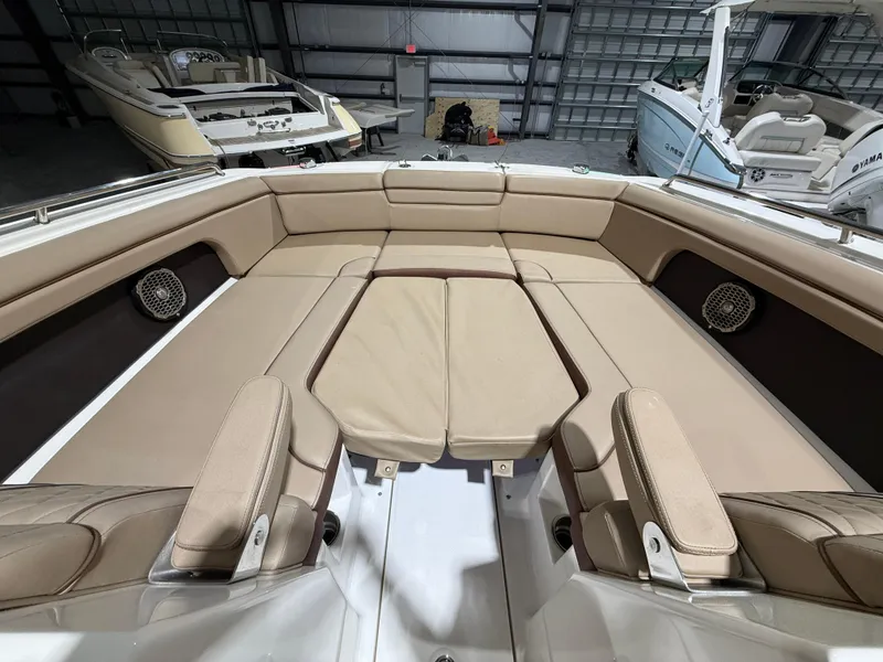 Slide: The Image of 2016 Sea Ray SDX 290 Outboard boat interior with beige seating in a storage facility. - 23