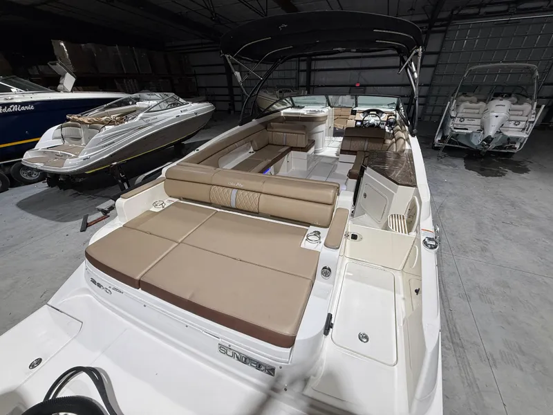 Slide: The Image of 2016 Sea Ray SDX 290 Outboard boat with spacious seating in a storage facility. - 9