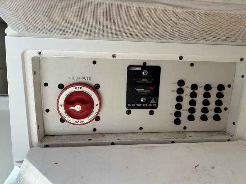 Slide: The Image of Control panel of a 2004 Wellcraft 252 Coastal boat, featuring switches and a Lewmar system. - 11