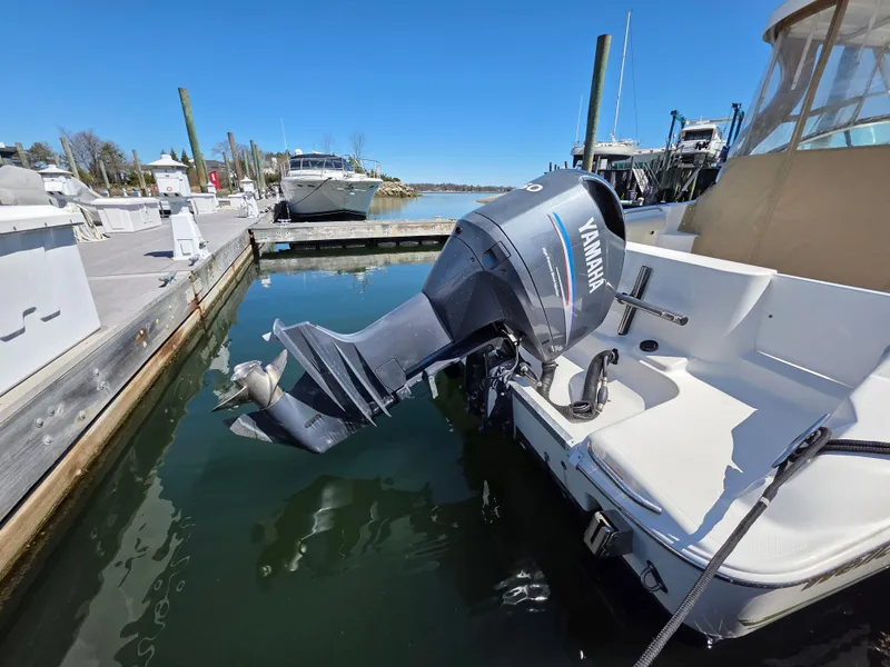 Slide: The Image of 2004 Wellcraft 252 Coastal boat with Yamaha outboard motor docked at marina. - 2