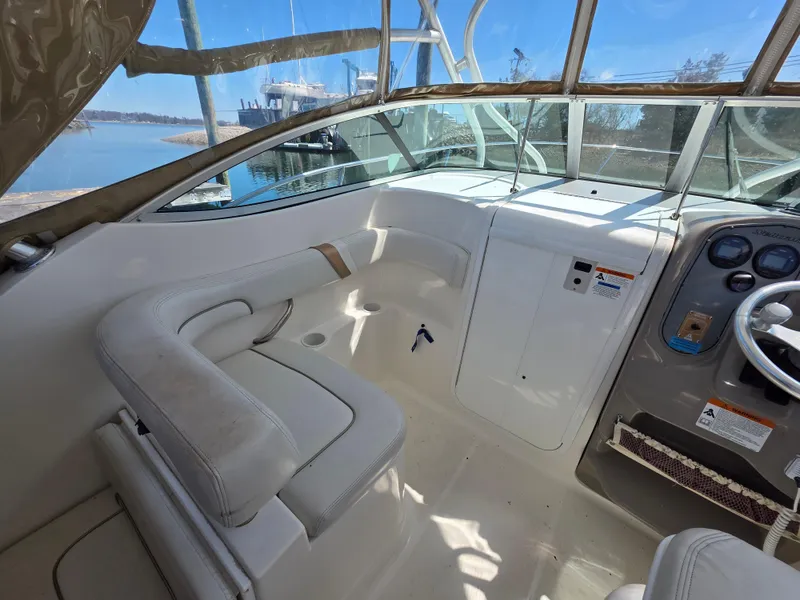 Slide: The Image of 2004 Wellcraft 252 Coastal boat interior with white seating and control panel. - 4