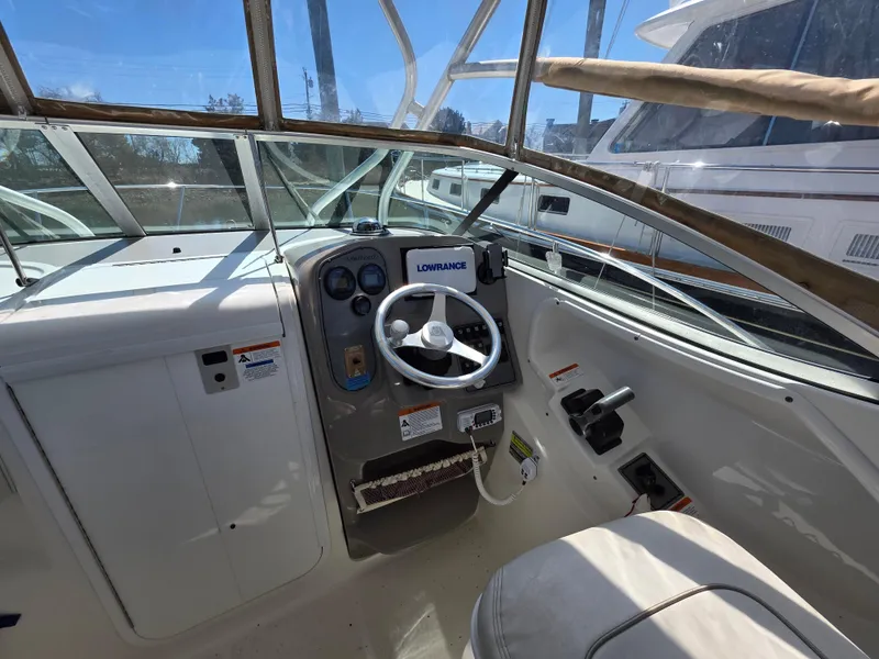 Slide: The Image of 2004 Wellcraft 252 Coastal boat cockpit with steering wheel and navigation equipment. - 5