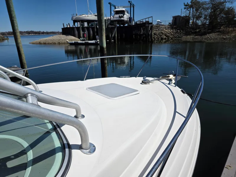 Slide: The Image of 2004 Wellcraft 252 Coastal boat docked in calm marina waters. - 8