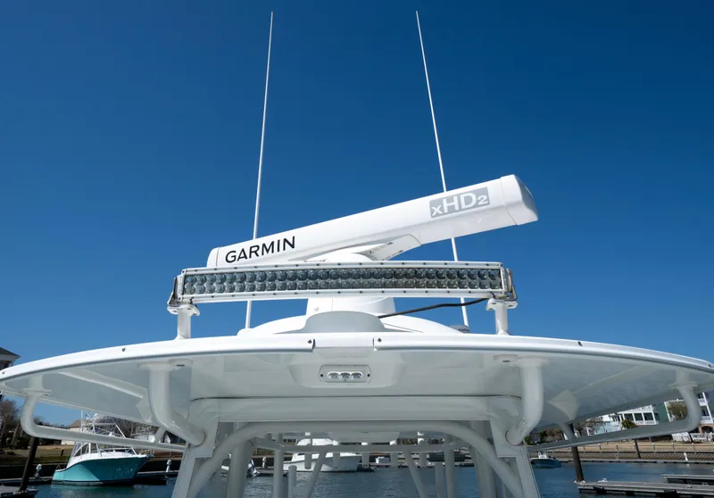 Slide: The Image of 2018 Yellowfin 32 Offshore boat with Garmin radar and antennas, docked under clear blue sky. - 13