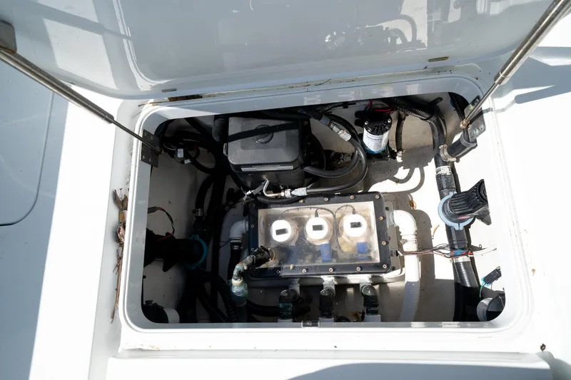 Slide: The Image of 2018 Yellowfin 32 Offshore boat engine compartment with visible components and wiring. - 14