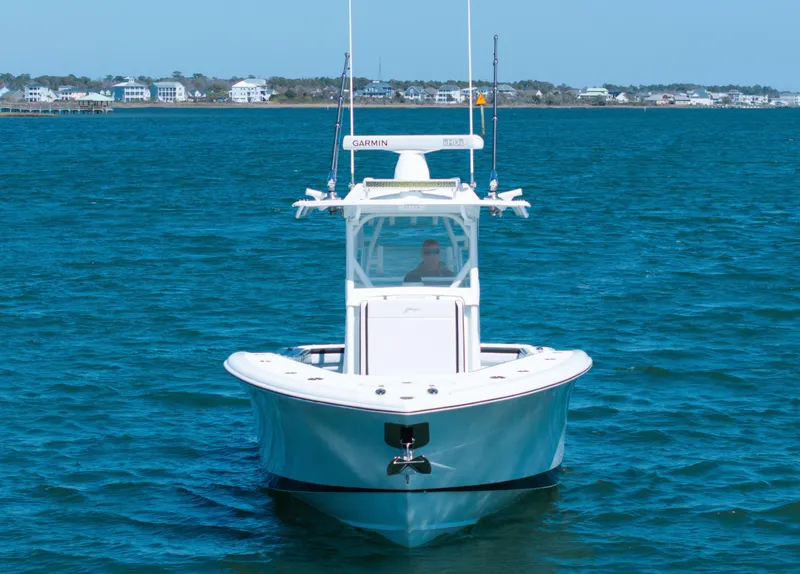 Slide: The Image of 2018 Yellowfin 32 Offshore boat on blue water, front view. - 20