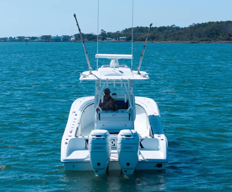 Slide: The Image of 2018 Yellowfin 32 Offshore boat on blue water, rear view. - 23