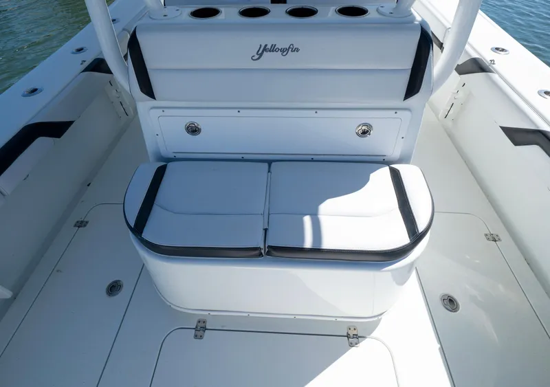 Slide: The Image of 2018 Yellowfin 32 Offshore boat interior with cushioned seating and storage compartments. - 7