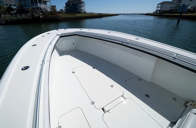 Slide: The Image of 2018 Yellowfin 32 Offshore boat on calm water, showcasing spacious deck and sleek design. - 8