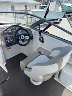 Slide: The Image of 2015 Stingray 234 Series boat interior with steering wheel and captain's chair. - 10