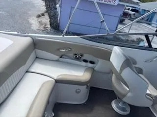 Slide: The Image of 2015 Stingray 234 Series boat interior with beige seating and steering chair. - 11