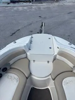 Slide: The Image of 2015 Stingray 234 Series boat interior with beige seating and white deck. - 14