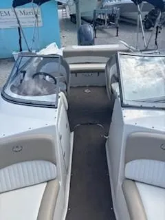 Slide: The Image of 2015 Stingray 234 Series boat interior with beige and white seating. - 15
