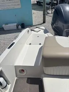 Slide: The Image of 2015 Stingray 234 Series boat interior with seating and engine view. - 19