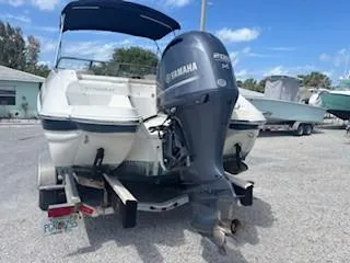 Slide: The Image of 2015 Stingray 234 Series boat with Yamaha outboard motor, parked on a trailer. - 7