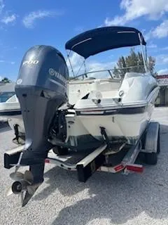 Slide: The Image of 2015 Stingray 234 Series boat with Yamaha outboard motor on trailer. - 8