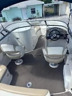 Slide: The Image of 2015 Stingray 234 Series boat interior with steering wheel and seating. - 9