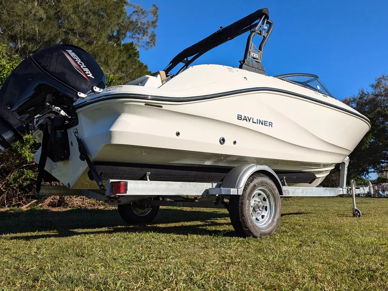 Slide: The Image of 2025 Bayliner V20 boat on trailer, side view, outdoors on grass. - 3