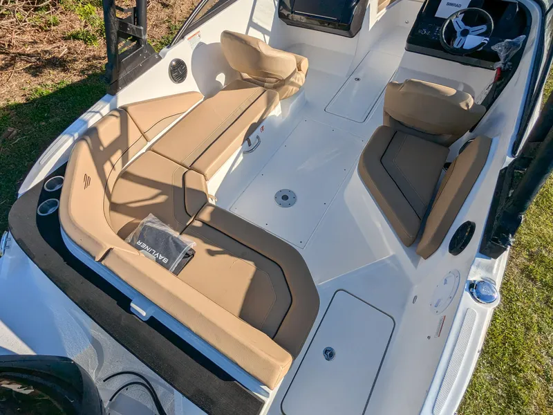 Slide: The Image of 2025 Bayliner V20 boat interior with tan seating and modern steering console. - 4