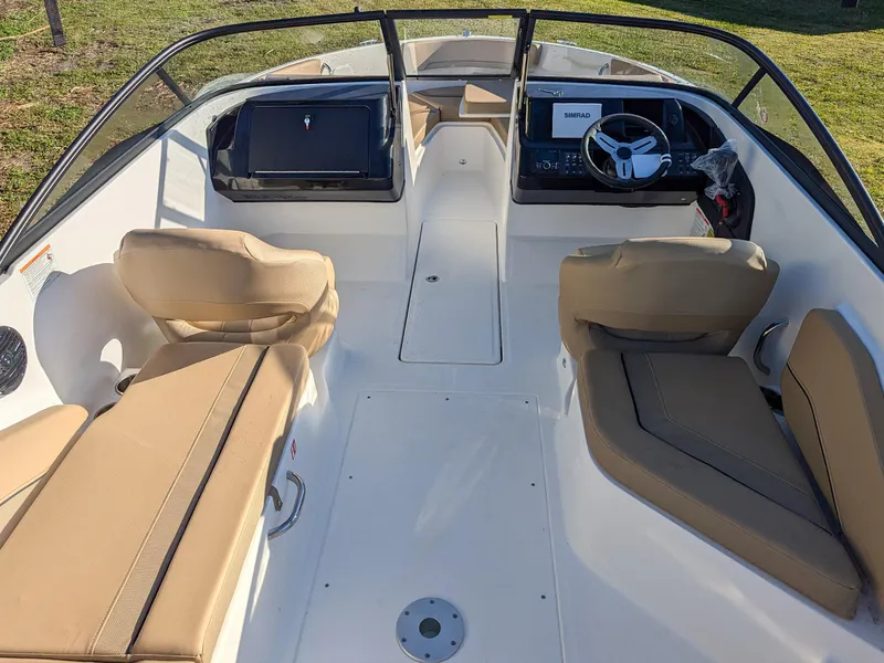 Slide: The Image of 2025 Bayliner V20 boat interior with beige seating and modern dashboard. - 5