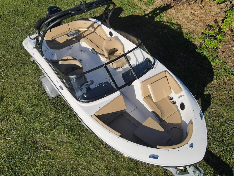 Slide: The Image of 2025 Bayliner V20 boat with beige interior, parked on grass. - 6
