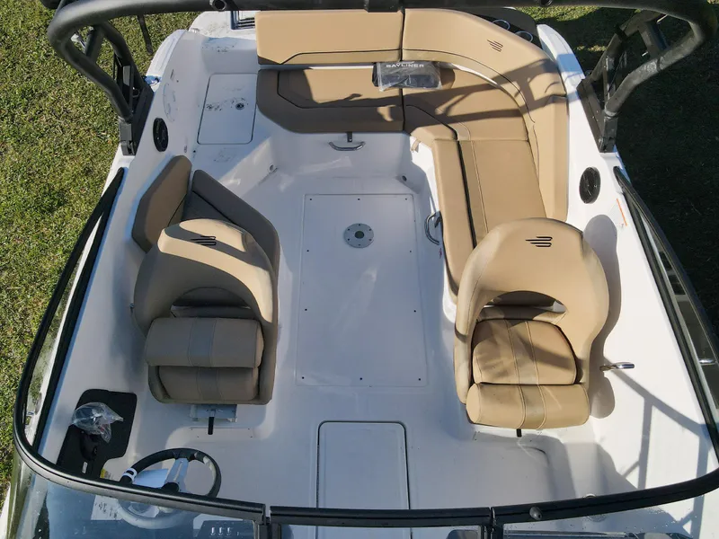 Slide: The Image of 2025 Bayliner V20 boat interior with beige seating and modern design. - 7