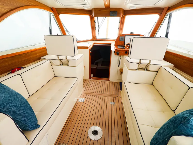 Slide: The Image of Luxurious interior of 2009 Legacy 32 boat with plush seating and wooden accents. - 10