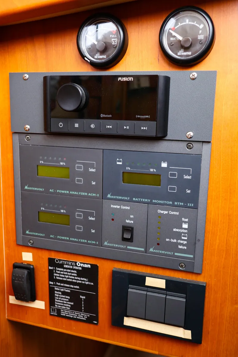 Slide: The Image of Control panel with gauges and switches on a 2009 Legacy 32 boat. - 16