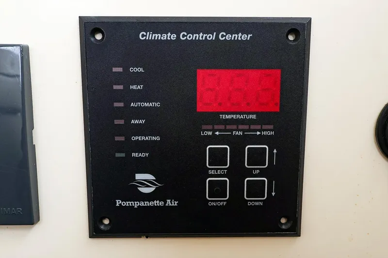 Slide: The Image of Climate control panel on 2009 Legacy 32, featuring temperature and fan settings. - 19
