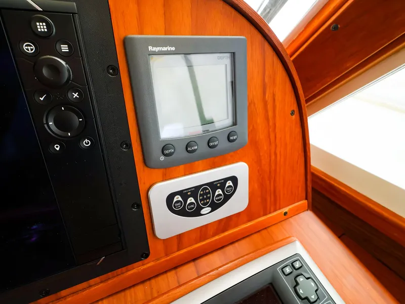 Slide: The Image of Boat dashboard with Raymarine display and control panel, Legacy 32, 2009 model. - 23